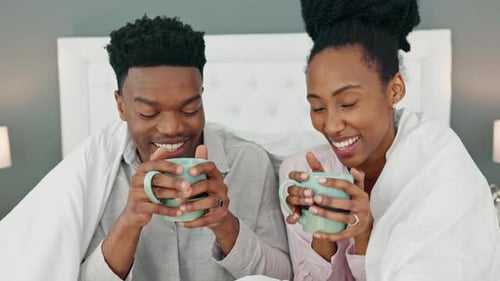 Happy Couple Drinking Coffee Together in Bed