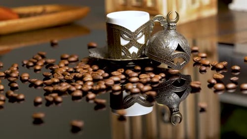 Coffee beans on reflecting surface with arabic or turkish coffee copper cup with beautiful design. 4