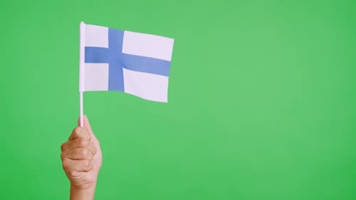 Hand Waving a Flag of Finland on Green Screen
