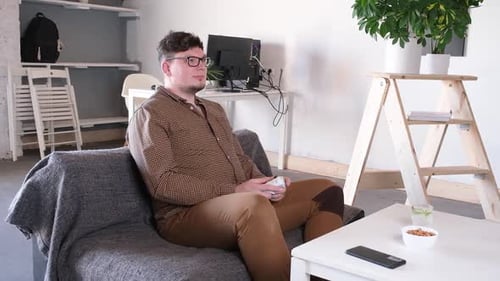 Man Playing Video Games on Couch Indoors