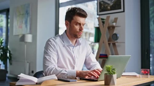 Frowned Executive Typing Email at Laptop Sitting Office Workplace Closeup