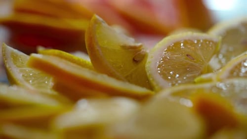 moving shot of a tray full of freshly cut lemon slices