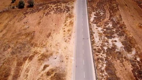 Flying over empty desert road