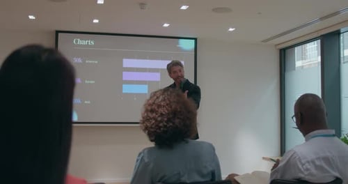 Presenter Giving Business Presentation in Office Meeting Room
