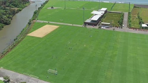 Bali united training center aerial view with players training on the pitch