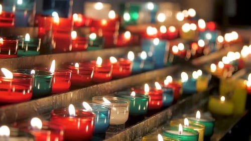 Colorful candles burning in church, religious prayers symbolism