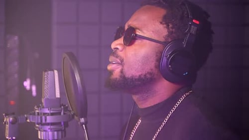 Black Man is Singing Romantic Song to Microphone in Recording Studio Talented Musician is a Star