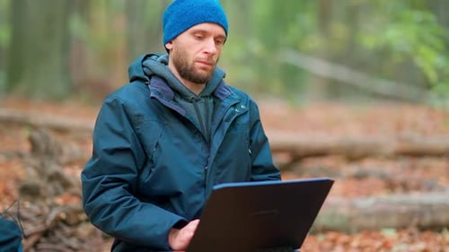 Man Computer Typing In Forest
