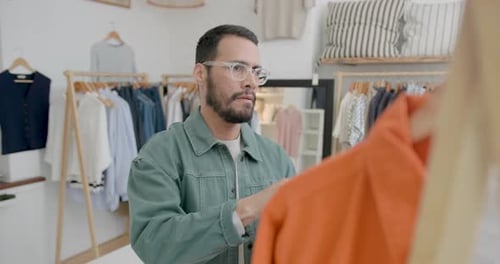 Man choosing clothes in a fashionable store