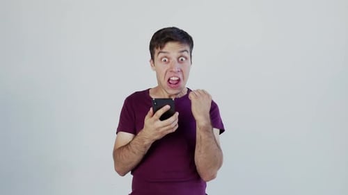 Man Reacts Excitingly to News on Phone