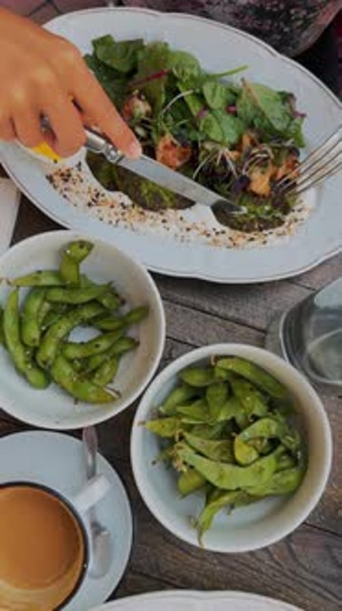 Healthy Vegan Brunch in the City Close Up of Breakfast Salad with Edamame Coffee
