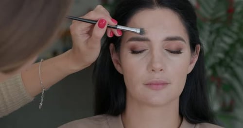 Makeup Process Face Contouring By a Makeup Artist for a Beautiful Girl