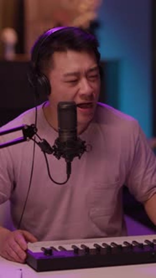 Man Singing with Microphone and Keyboard at Home