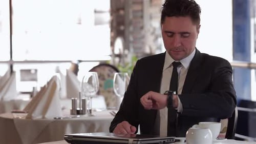 Man in Suit Waiting in Restaurant