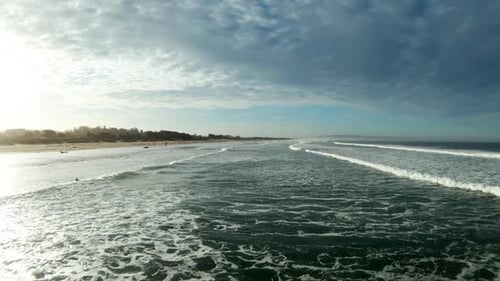 Serene Coastal Beach Landscape with Rolling Ocean Waves at Sunrise