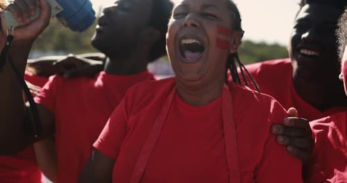 Enthusiastic fans cheer and celebrate a sporting event