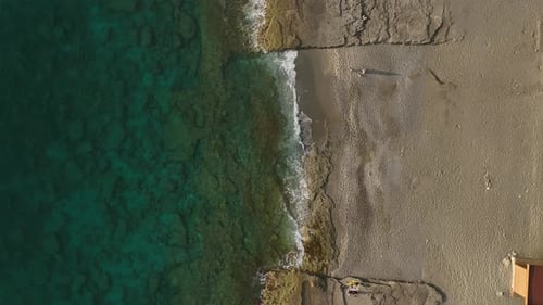 Aerial View A Stunning View of a Golden Beach and Sparkling Waters Highlights the Serene Charm of a