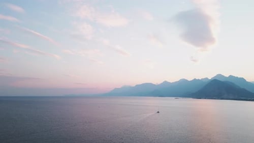 Sailboat Glides on Ocean at Dreamy Sunset