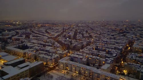 Berlin City lights, rooftops covering in snow winter at dusk. Tremendous aerial view drone