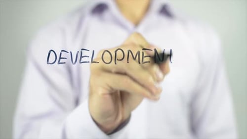 Writing the Word Development on a Clear Surface