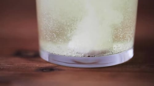Effervescent Tablet Dissolving in Glass of Water