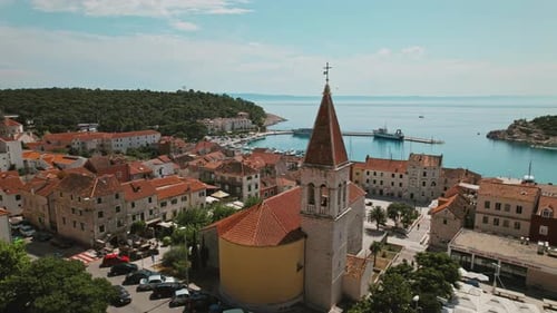 Scenic Overlook of Harbor with Boats Moored in Calm Bay. Bustling marina against cityscape. Seaside