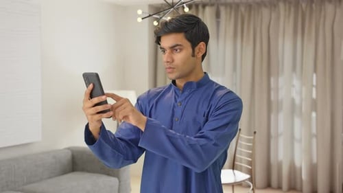 Indian man using mobile phone