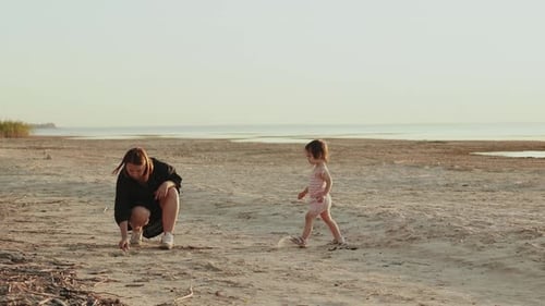 A Beautiful and Serene Beach Moment Shared Between a Child and a Parent Enjoying Nature