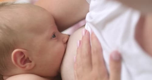 Infant Breastfeeding Close Up At Home