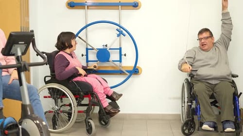 People Using Exercise Machines in Physical Therapy Setting