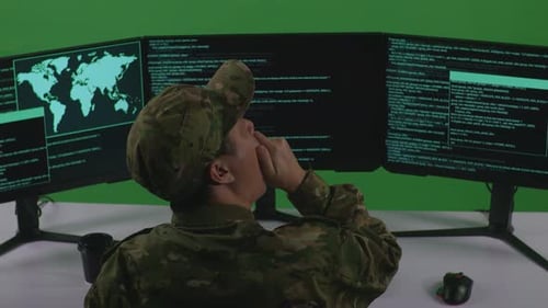 Tired Asian Man Soldier Yawning While Write Code With Multiple Computer Screens In Green Screen