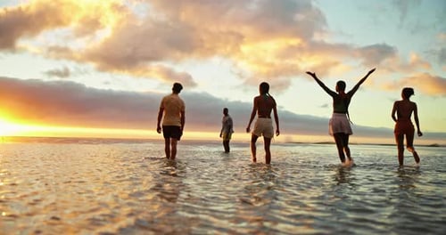 Water, friends and people on beach at sunset for holiday, vacation and weekend together
