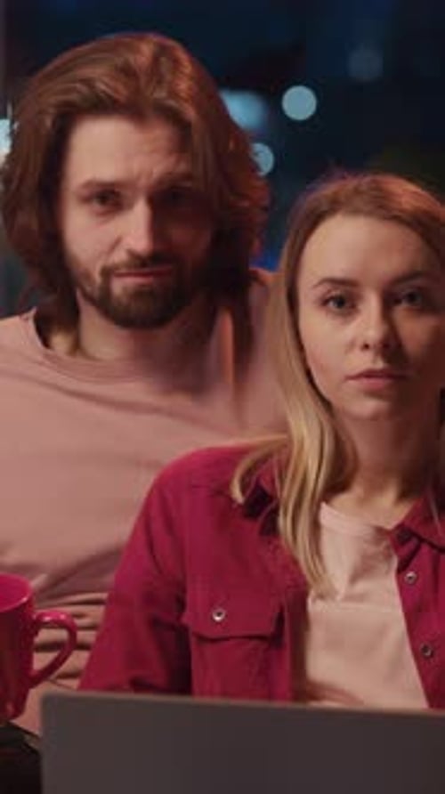 Young Adults Using Laptop in Cozy Indoor Setting