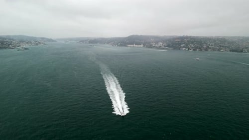 Small boat in the Bosphorus strait during cloudy weather