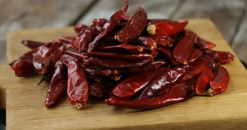Pile of Spicy Dried Red Chili Peppers on Wood