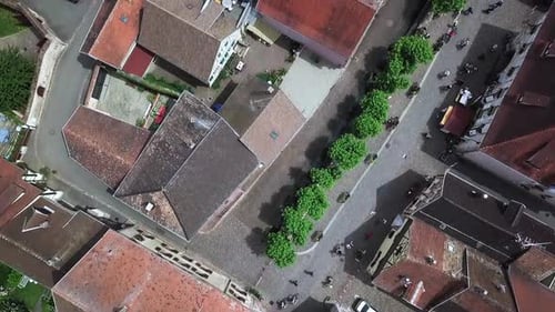 An onward-moving top-view aerial footage of the village from the clock tower while revealing the hou