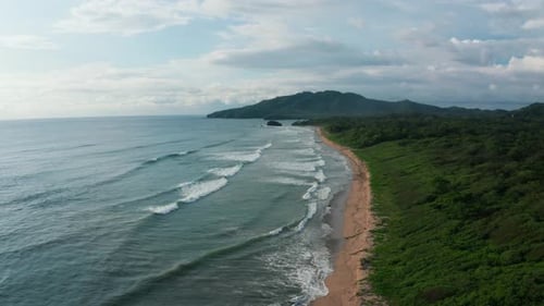 Beautiful 4K aerial drone shot of a tropical Pacific paradise beach at the seaside coast in Costa Ri