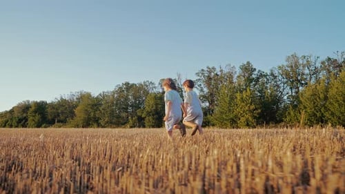 Brothers Kids Running Hand In Hand Across Open Field Golden Hourbest Friends