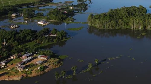 Aerial view of rural village with houses surrounded by flood water in Bangladesh. Flooded area