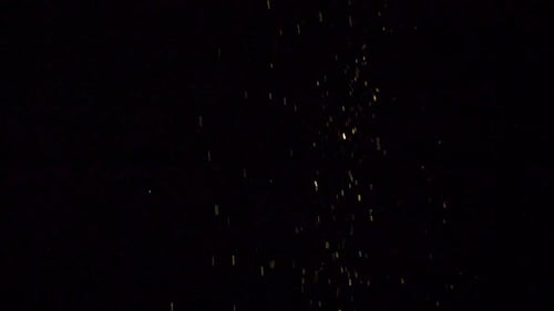 Golden Particles Rising on Black Background