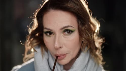 Woman Sipping Drink from Straw Close Up