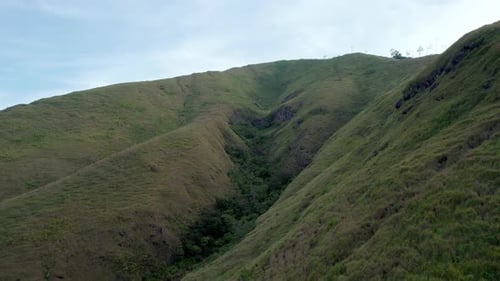 Aerial View of Narrow Green Valley Between Hills