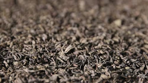 Pile of dried tea leaves as background, closeup