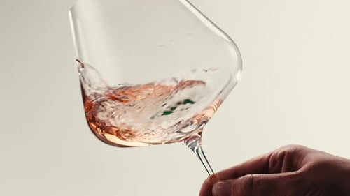 Orange or White Wine Bottle and Glass Against a Sunset in a Peaceful Vineyard Pouring of Ecological