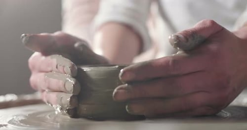 Child and Adult Making Pottery Together