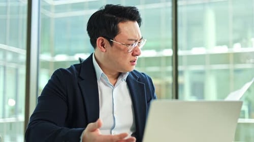Stressed Businessman Having Problems at Work in Office