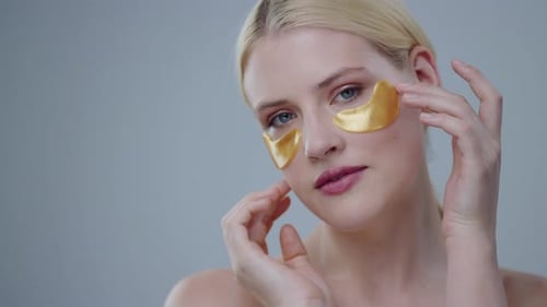 Blonde Woman Using Gold Eye Patches