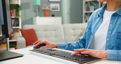 Close Up of Caucasian Young Pretty Blonde Woman Working While Sitting at Table Looking at Camera and