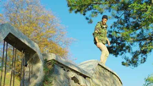 Young Adult Skateboarding and Jumping in Urban Park