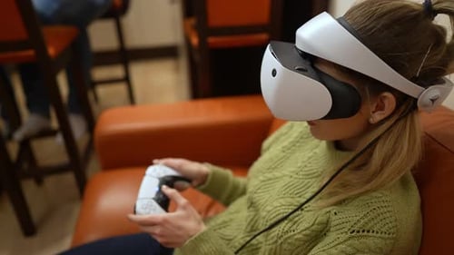 Woman Playing Video Game in Virtual Reality Headset